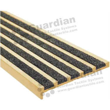Slimline premium recessed stair nosing in brass anodisation (10x75mm) with 5 x black carborundum infill 
